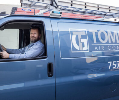 Tommy Garner Air Conditioning and Heating Van with smiling team member