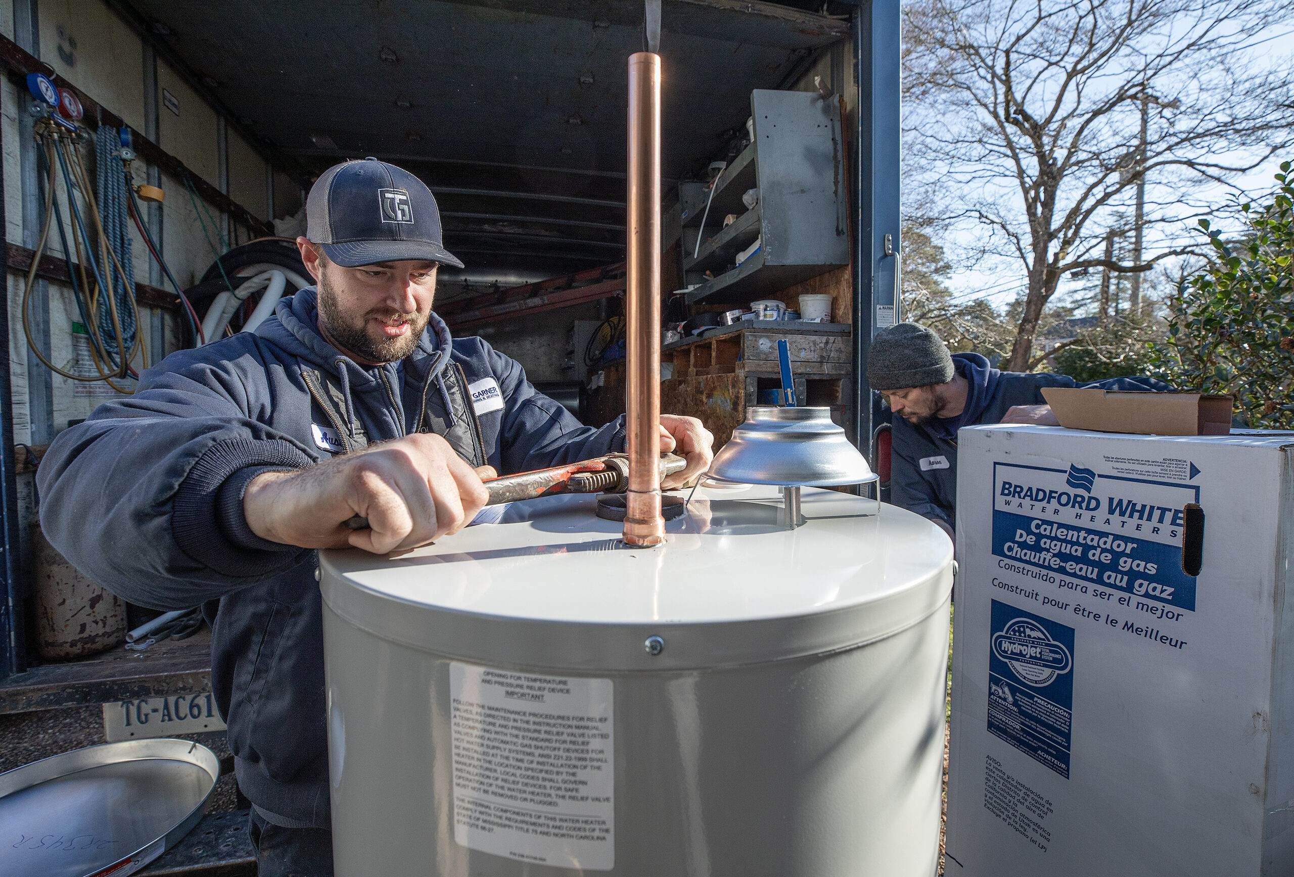 Tommy Garner employee working on installation of new water heater for customer